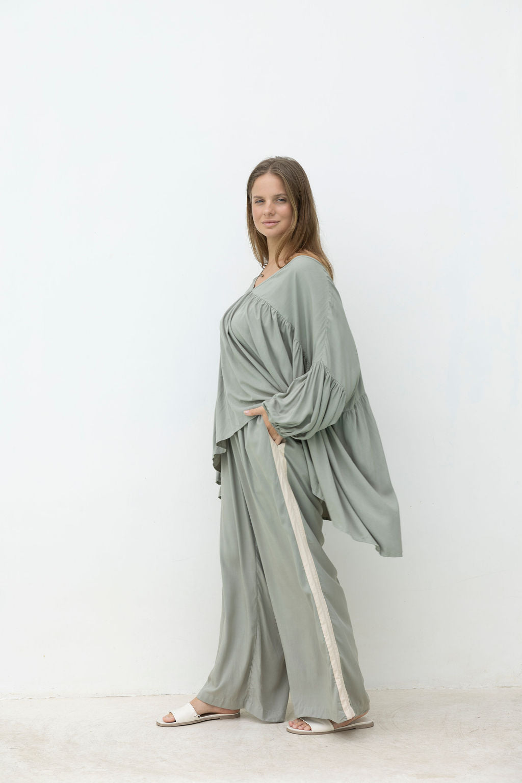 Woman wearing a light green dress with a white background