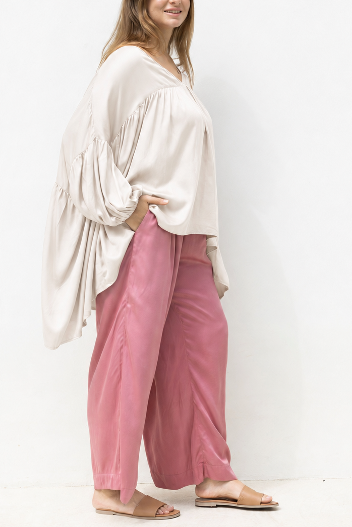 Woman wearing the Florence Top in White Sand, relaxed oversized fit, boho style, luxe satin fabric