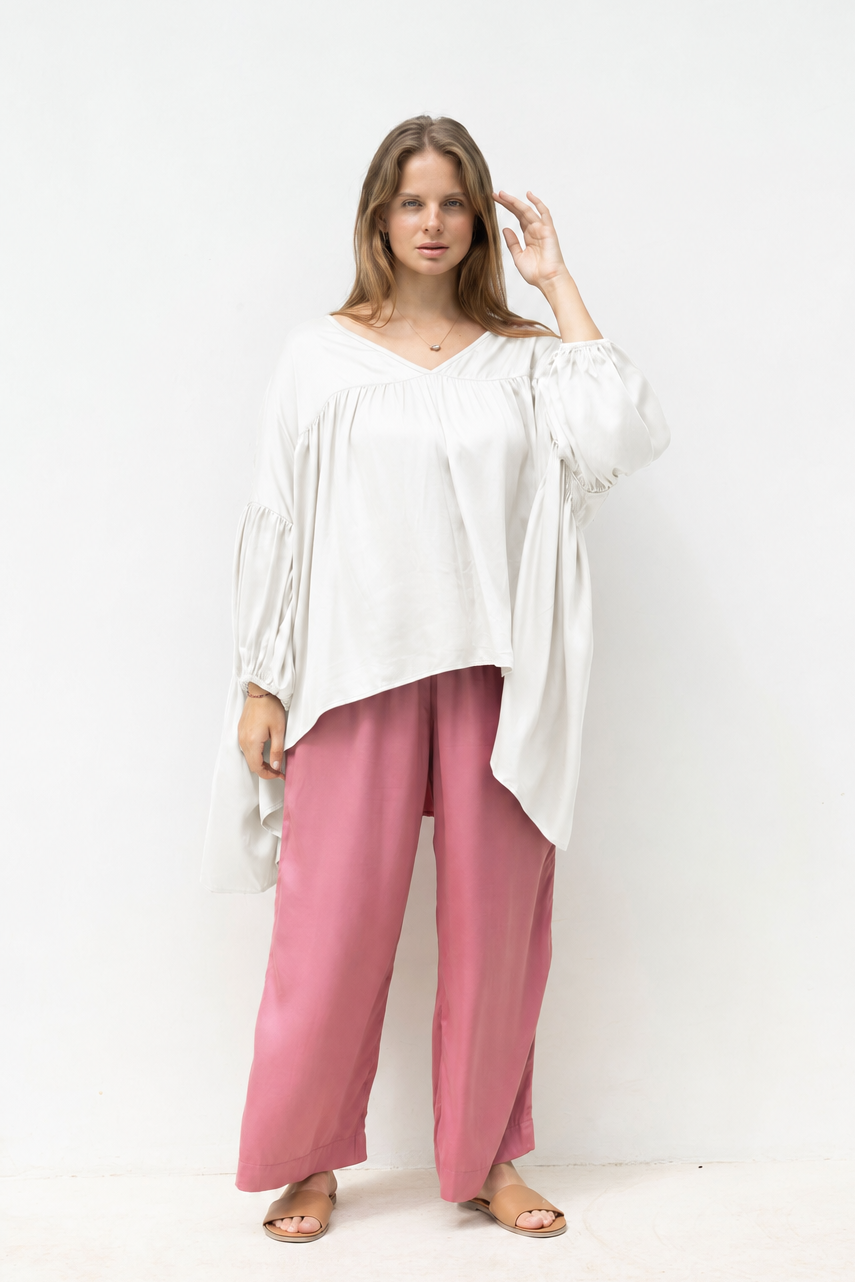 Woman wearing the Florence Top in White Sand, relaxed oversized fit, boho style, luxe satin fabric