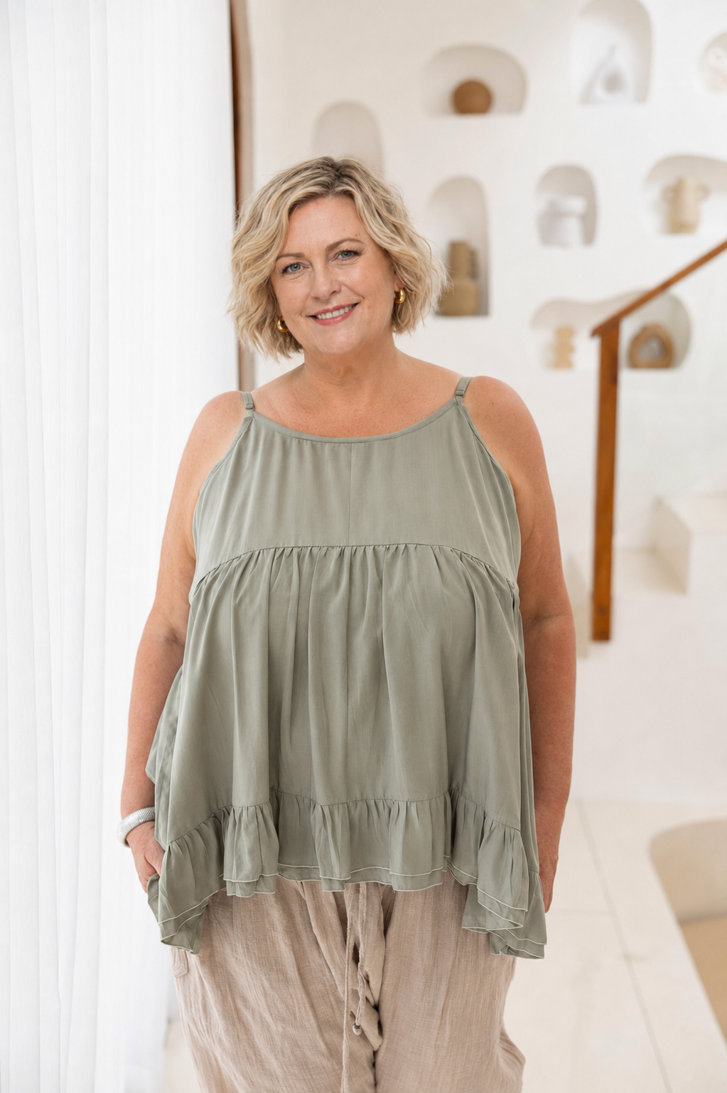 Woman wearing Ipanema Cami in Sage. Relaxed fit with a ruffle hem.