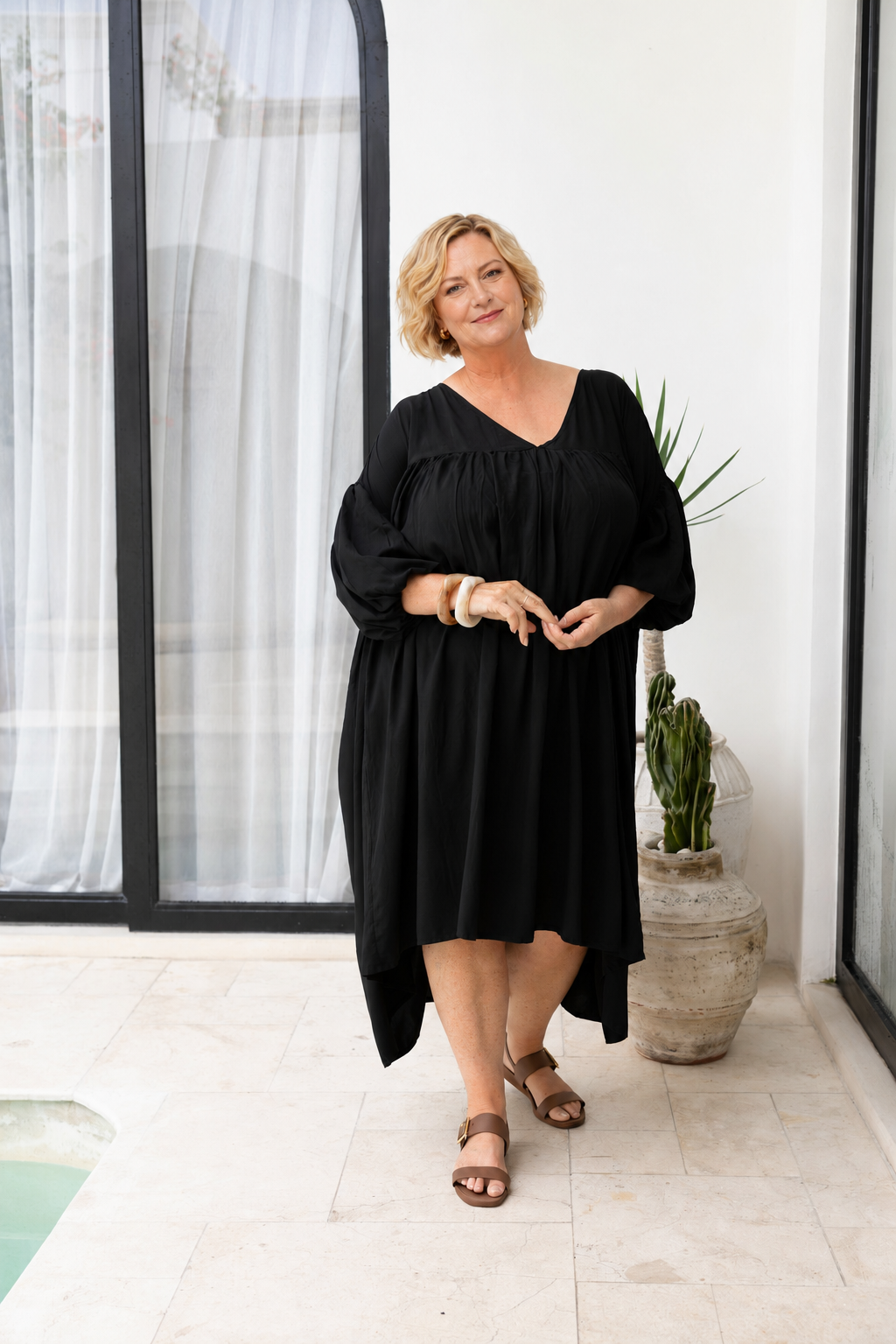 Woman wearing the Roma Dress in Black, relaxed oversized fit, boho style