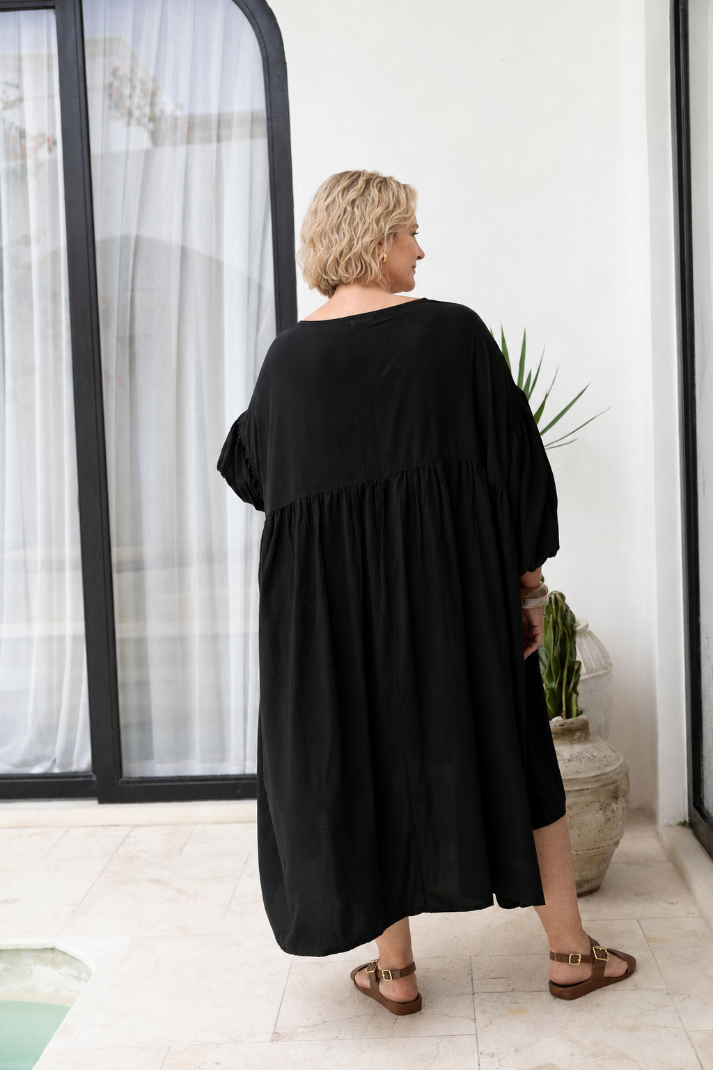 Woman wearing the Roma Dress in Black, relaxed oversized fit, boho style
