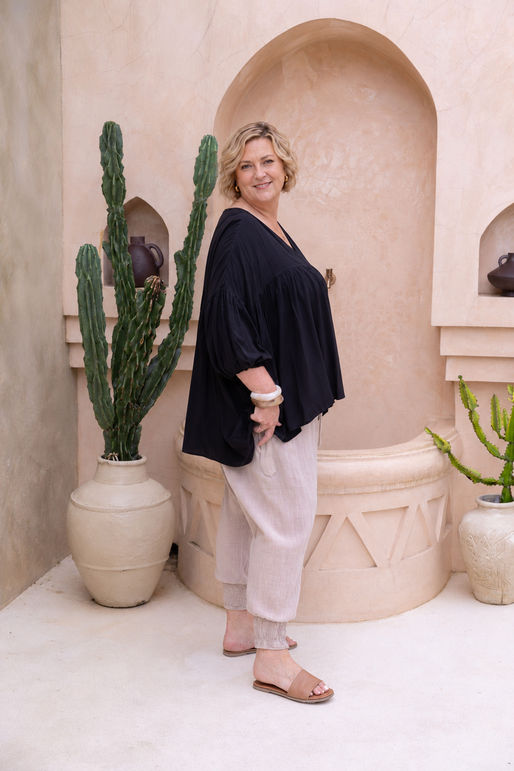Woman wearing the Florence Top in Black, relaxed oversized fit, boho style