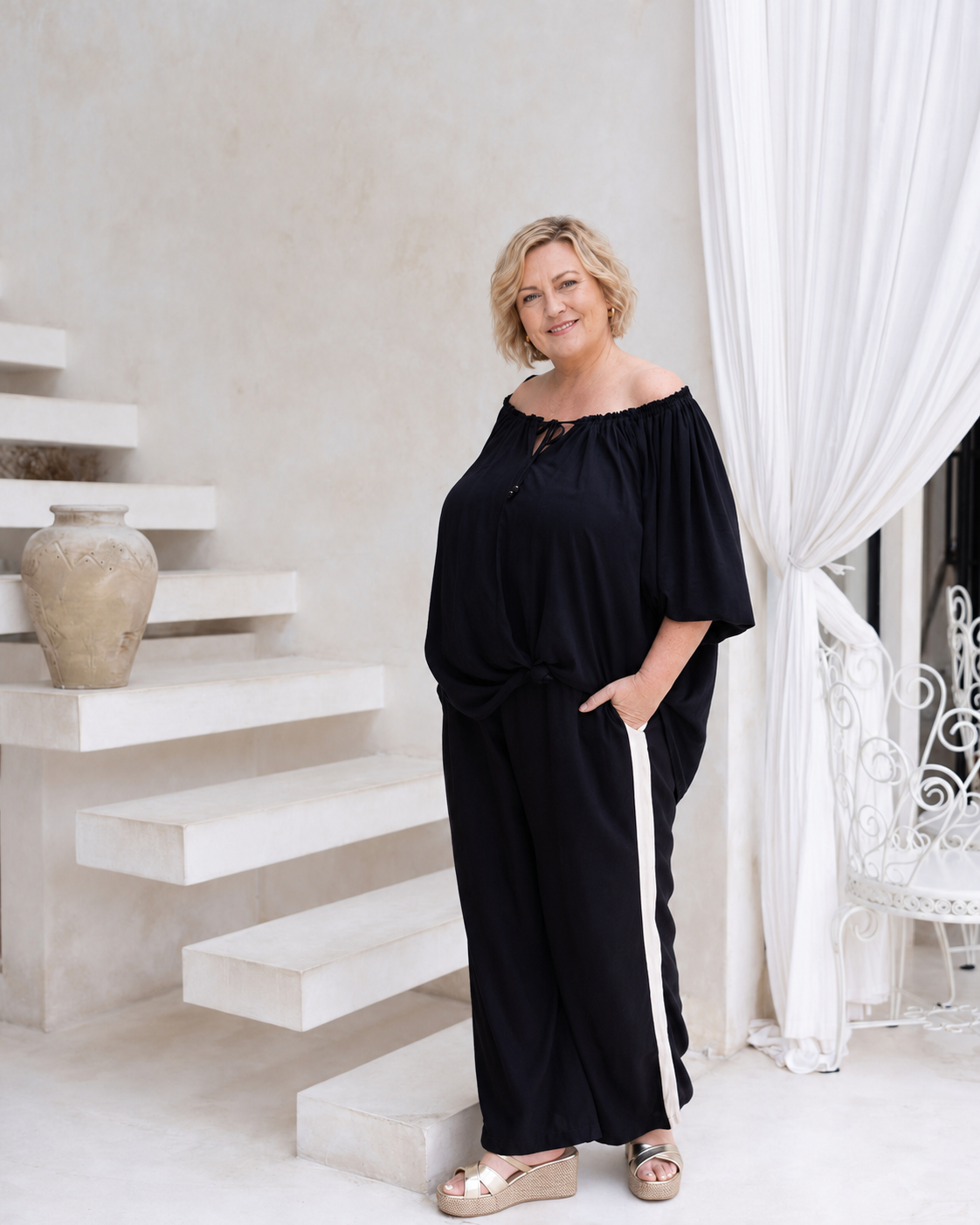 Woman wearing the Perfect Tuxedo Pant in Black with Stone Stripe, fluid wide-leg fit, effortlessly elevated style