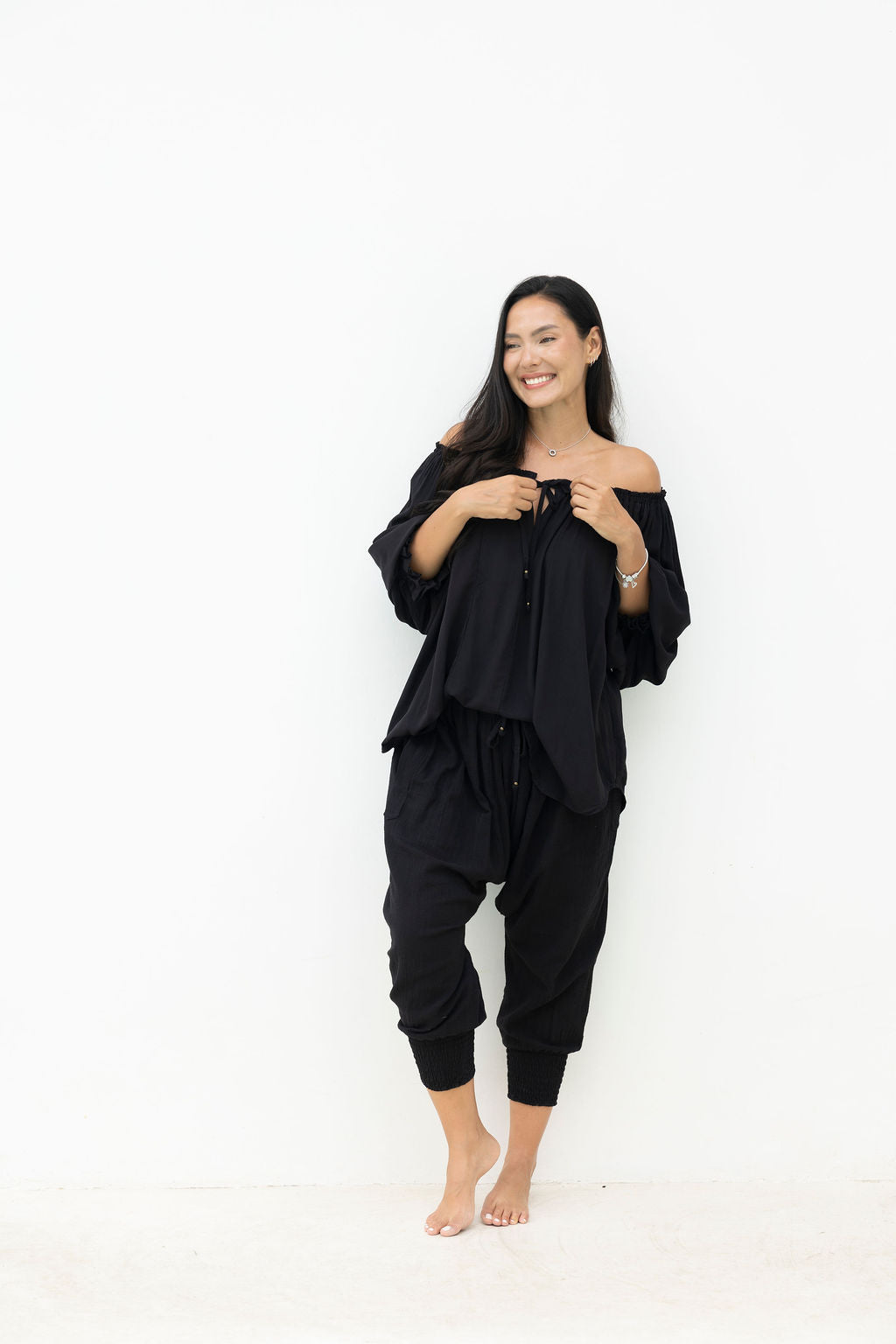 Woman wearing a black outfit on a white background