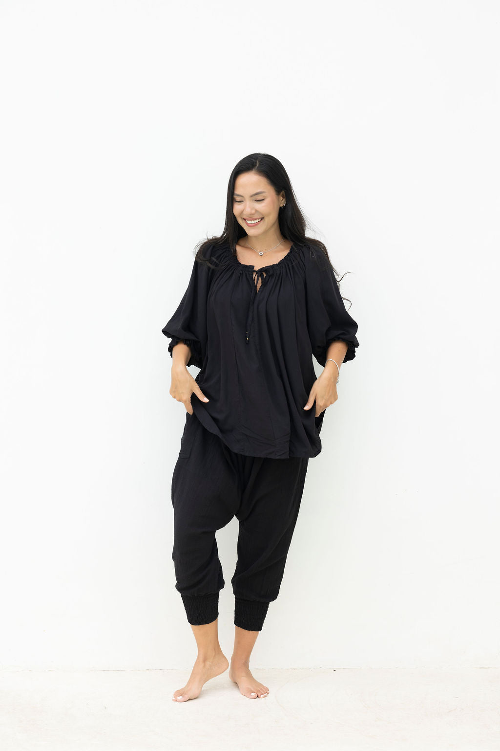 Woman wearing a black outfit on a white background