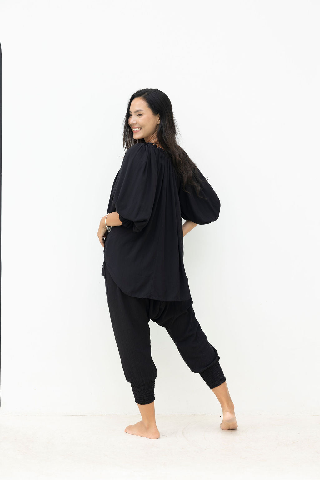 Woman wearing a black outfit on a white background