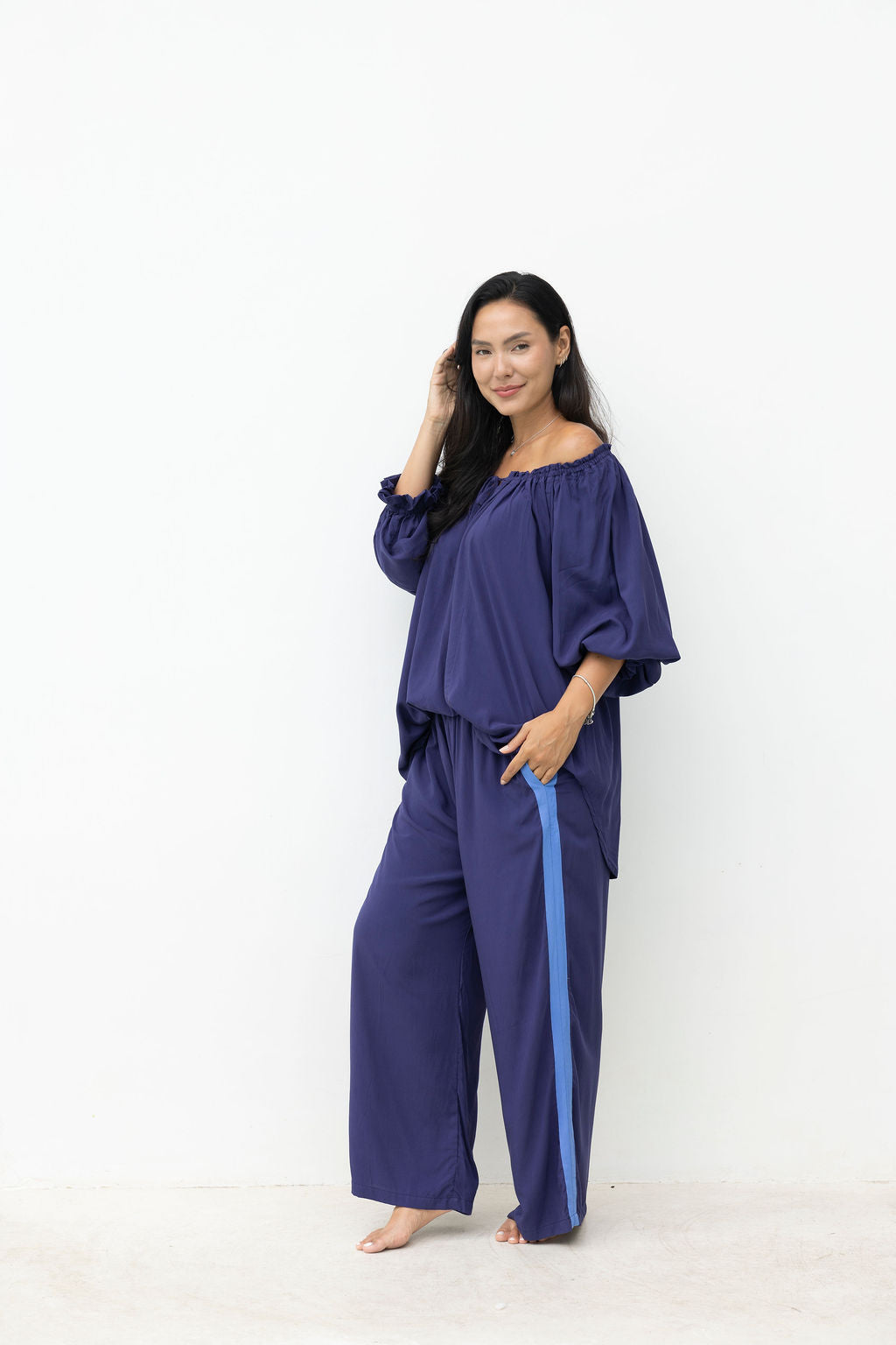 Woman wearing a blue outfit against a white background