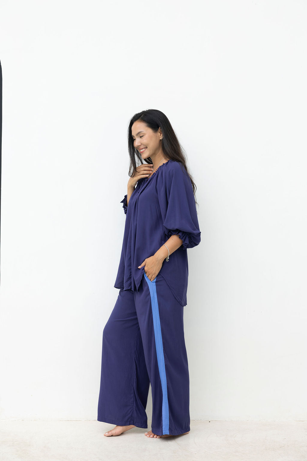 Woman wearing a blue outfit with a white background