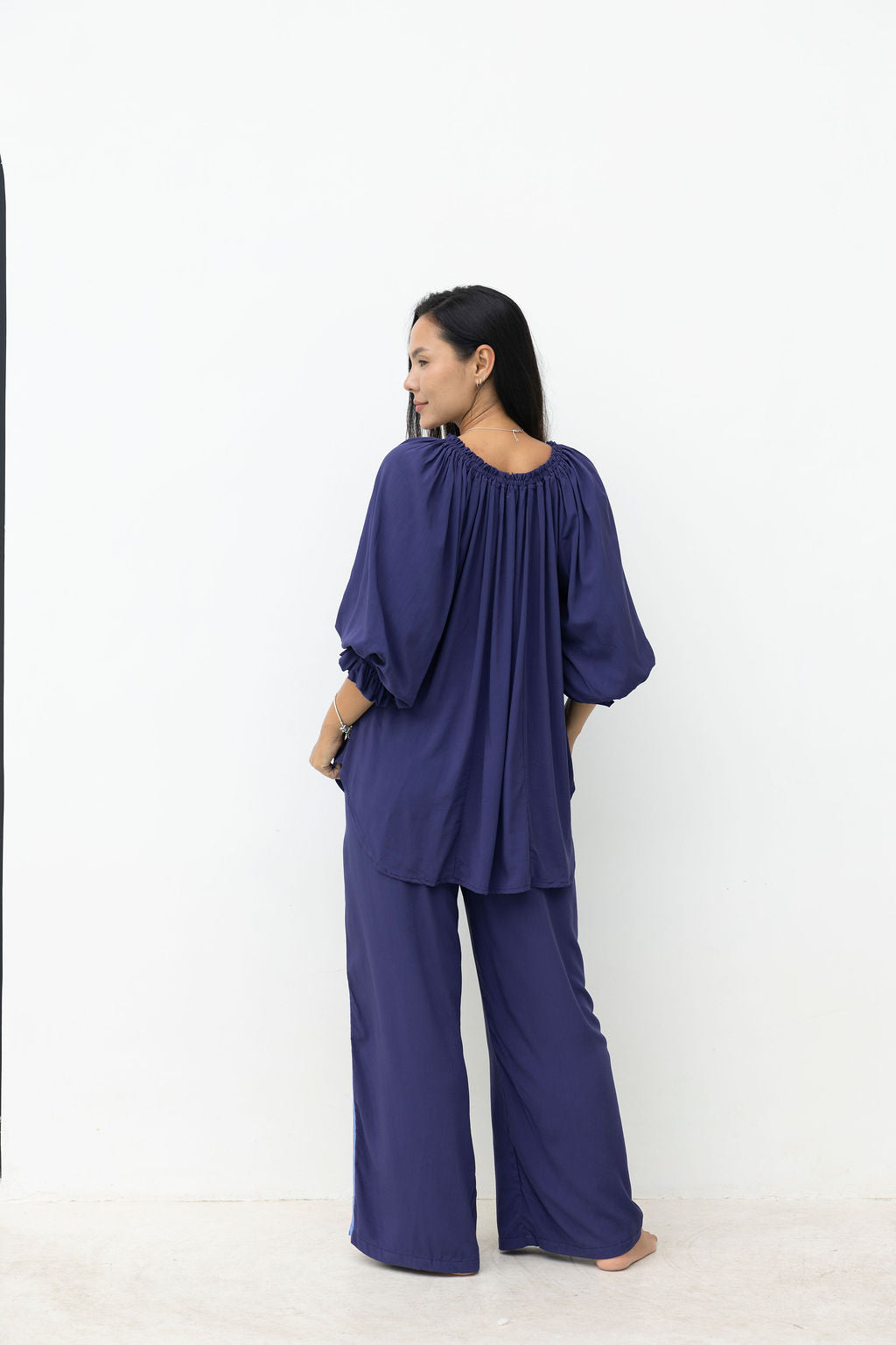 Woman wearing a blue outfit on a white background