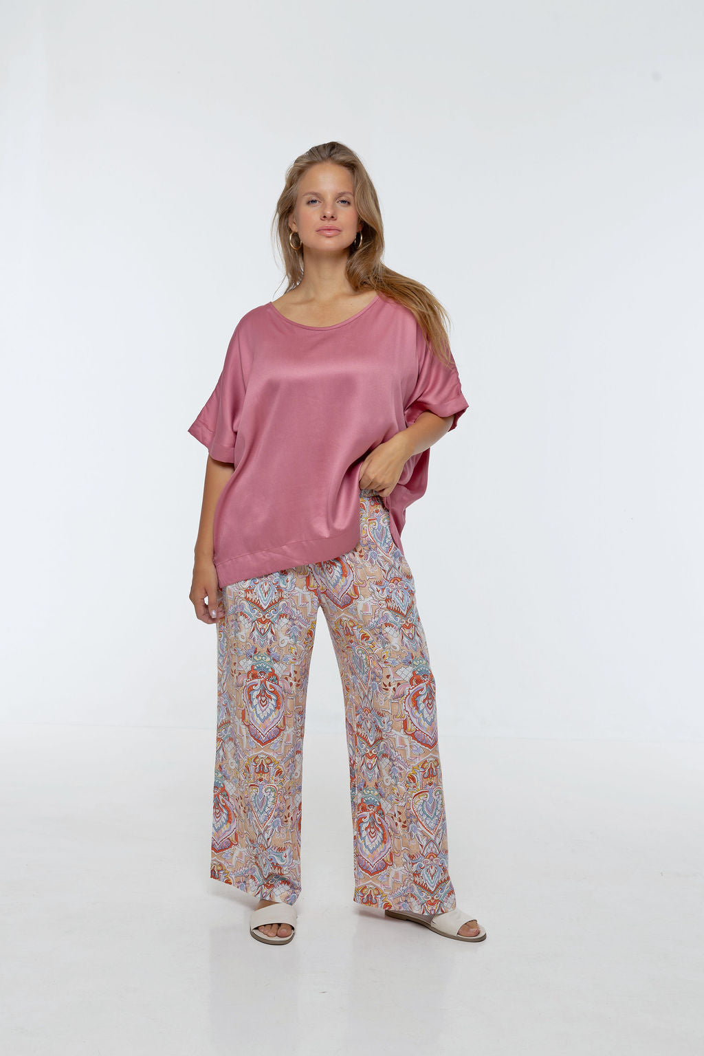 Woman wearing printed Rimini Pant. Wide leg style, relaxed fit, Braided Trim side stripe.