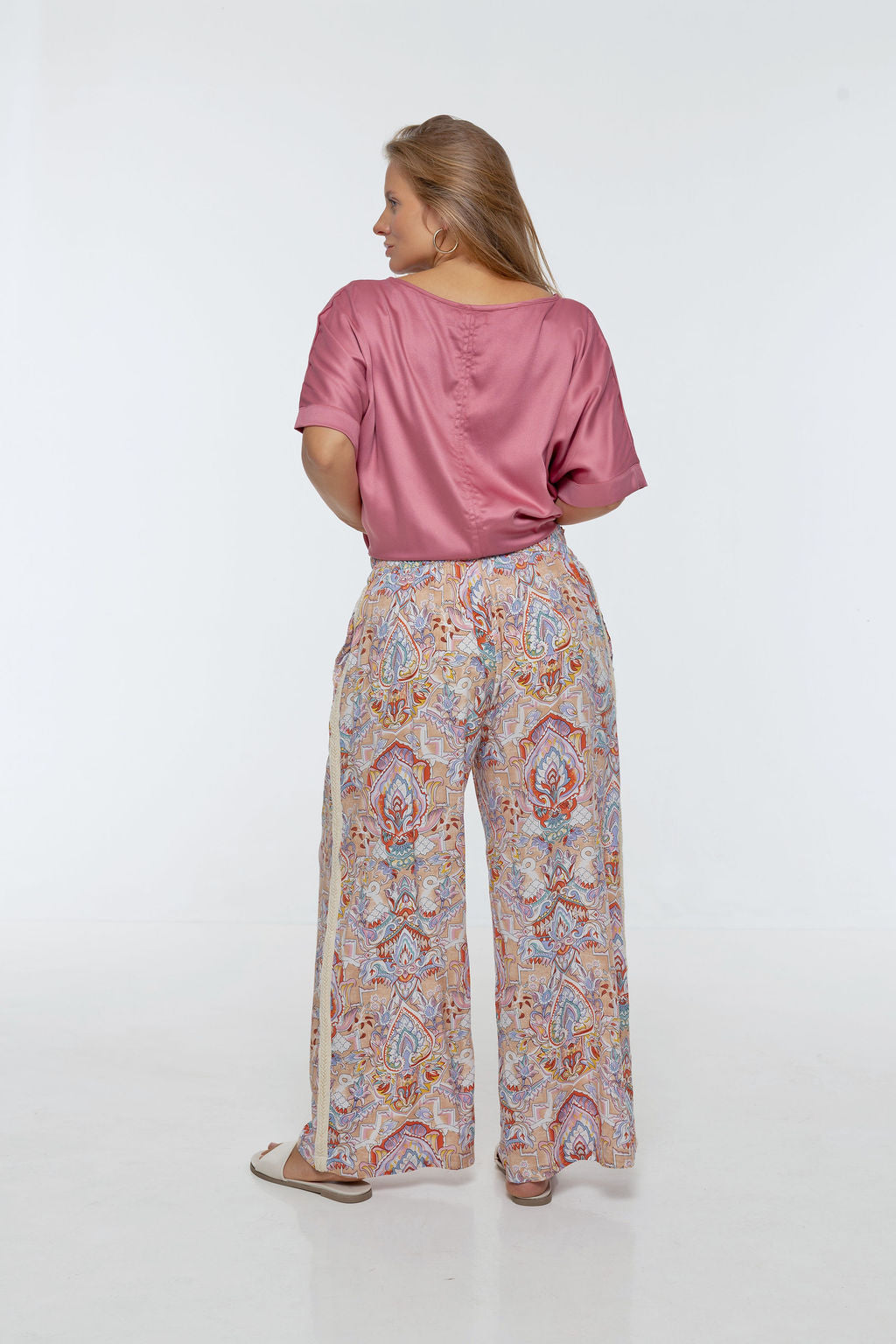 Woman wearing printed Rimini Pant. Wide leg style, relaxed fit, Braided Trim side stripe.
