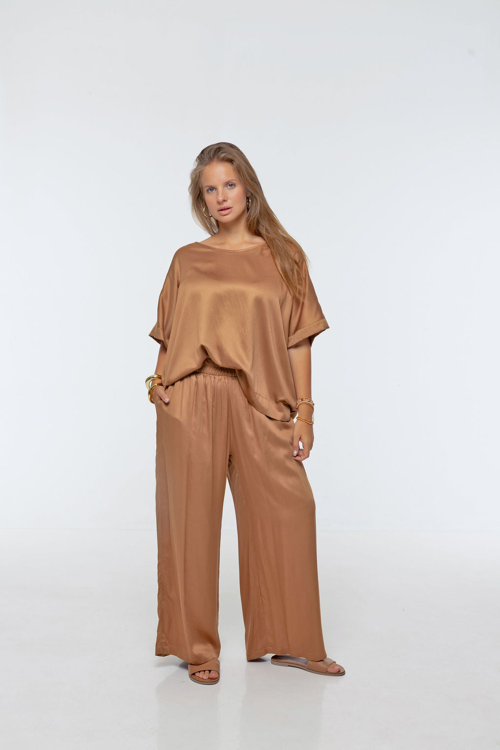 Woman wearing Rimini Pant in Walnut - Luxe Satin. Wide leg style, relaxed fit.