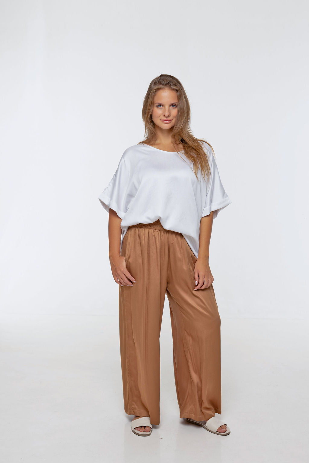 Woman wearing Rimini Pant in Walnut - Luxe Satin. Wide leg style, relaxed fit.