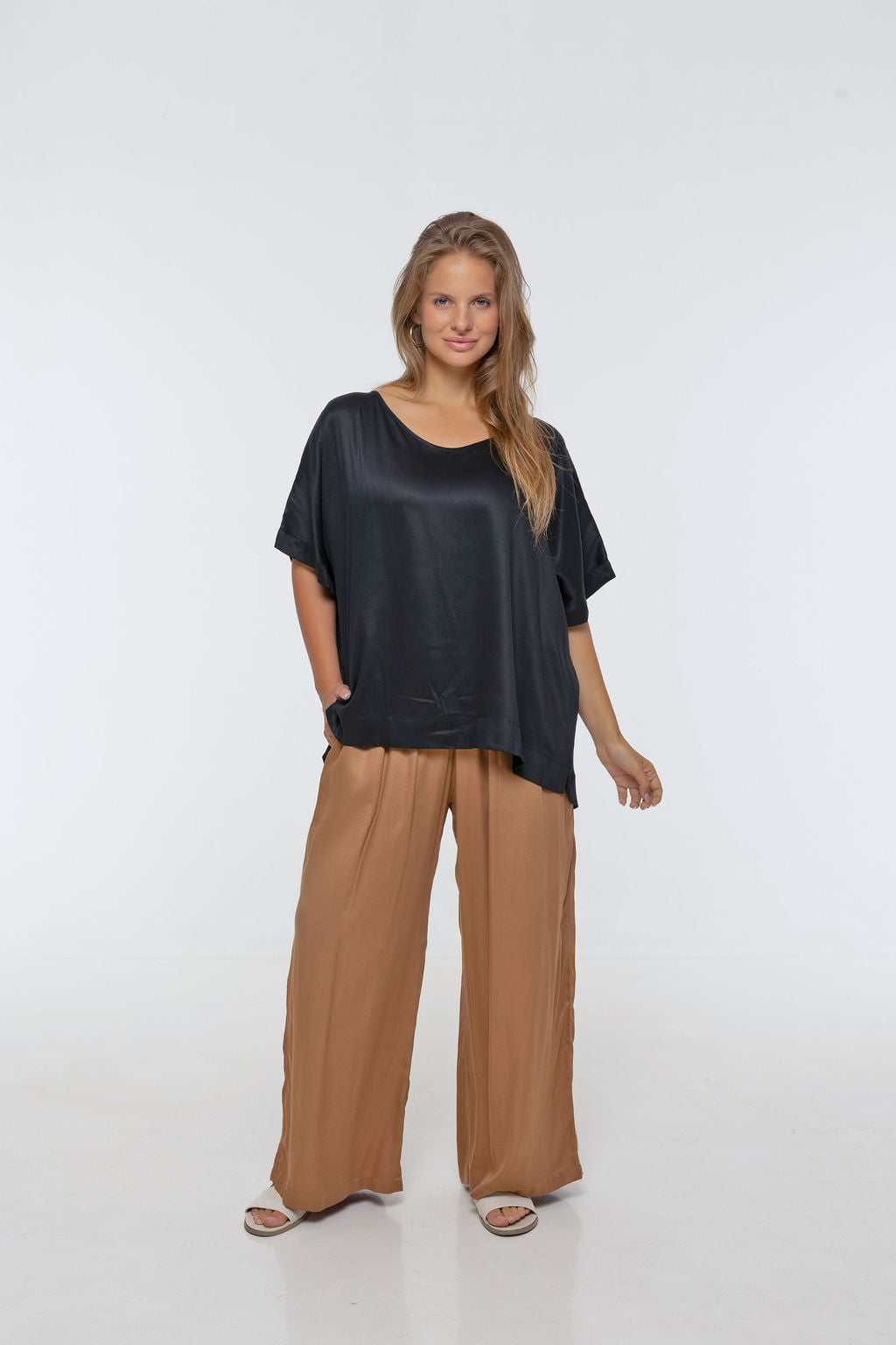 Woman wearing Rimini Pant in Walnut - Luxe Satin. Wide leg style, relaxed fit.