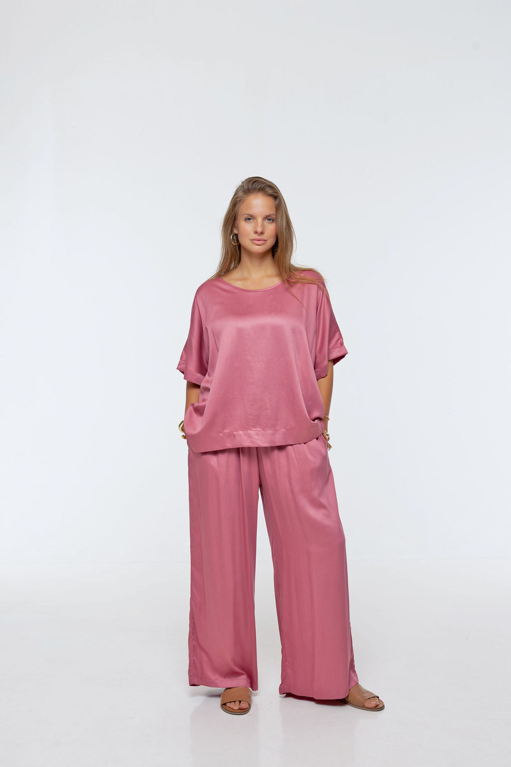 Woman wearing Rimini Pant in Dusty Pink - Luxe Satin. Wide leg style, relaxed fit.