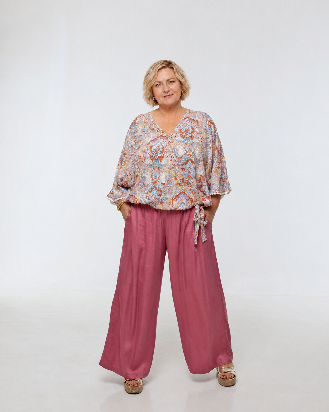 Woman wearing Rimini Pant in Dusty Pink - Luxe Satin. Wide leg style, relaxed fit.