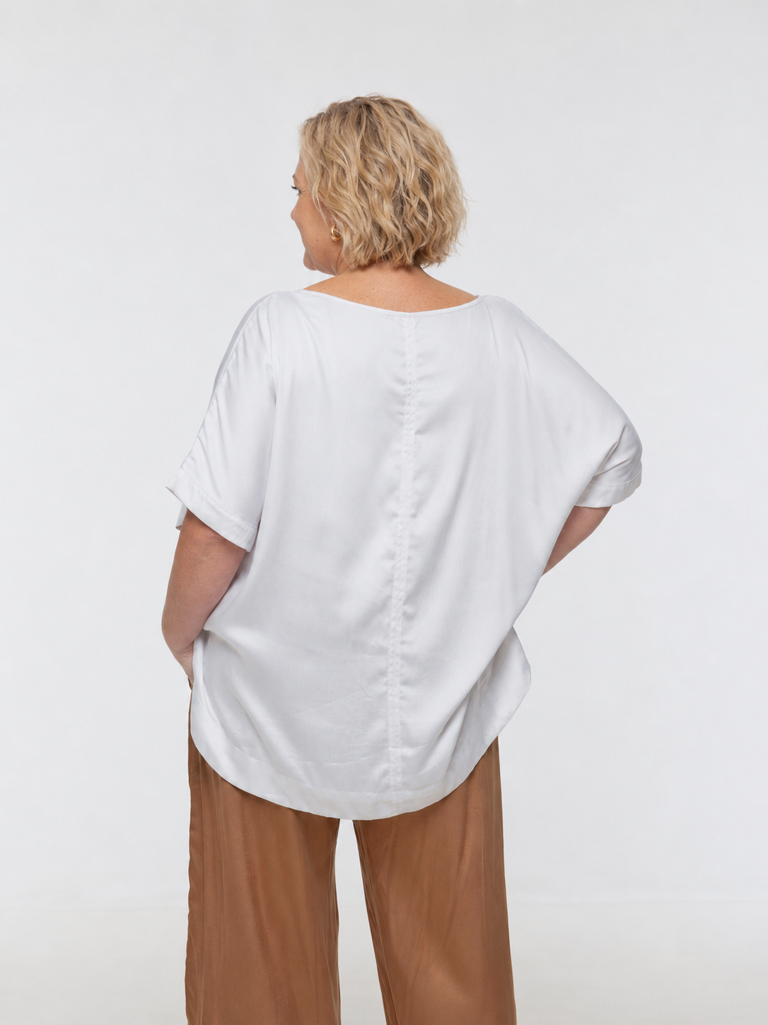 Woman wearing Salina Top in White Sand - Luxe Satin. Relaxed fit, elbow length Dolman sleeve
