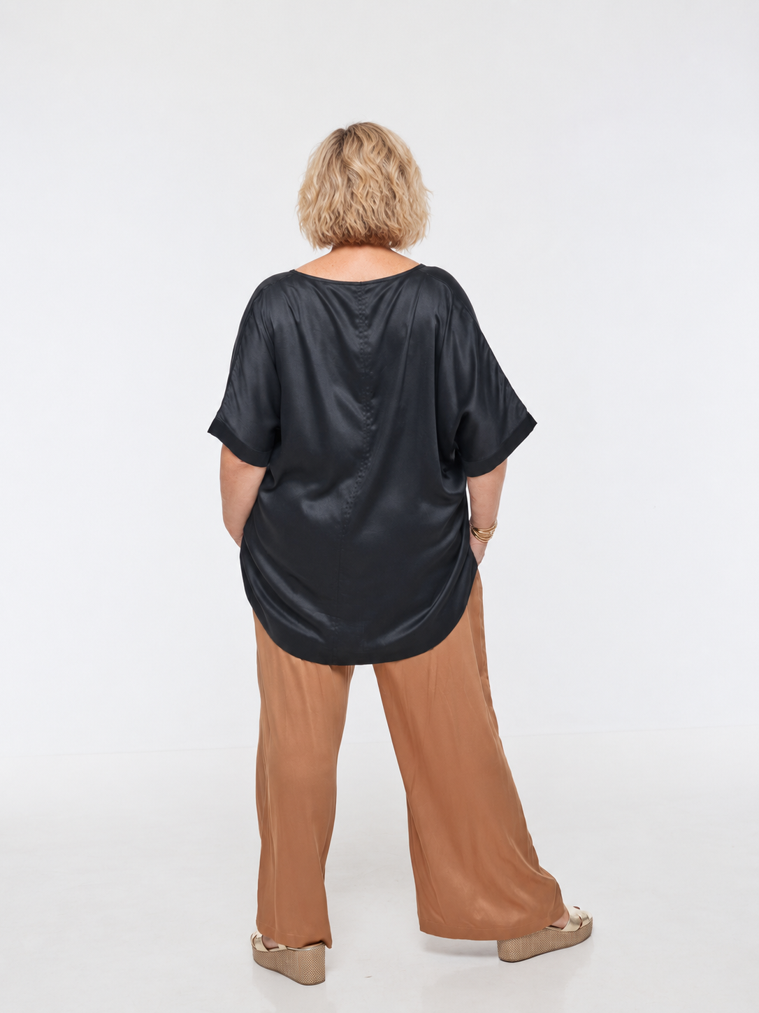 Woman wearing Salina Top in Black - Luxe Satin. Relaxed fit, elbow length Dolman sleeve