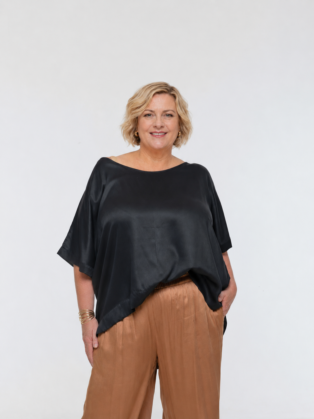 Woman wearing Salina Top in Black - Luxe Satin. Relaxed fit, elbow length Dolman sleeve