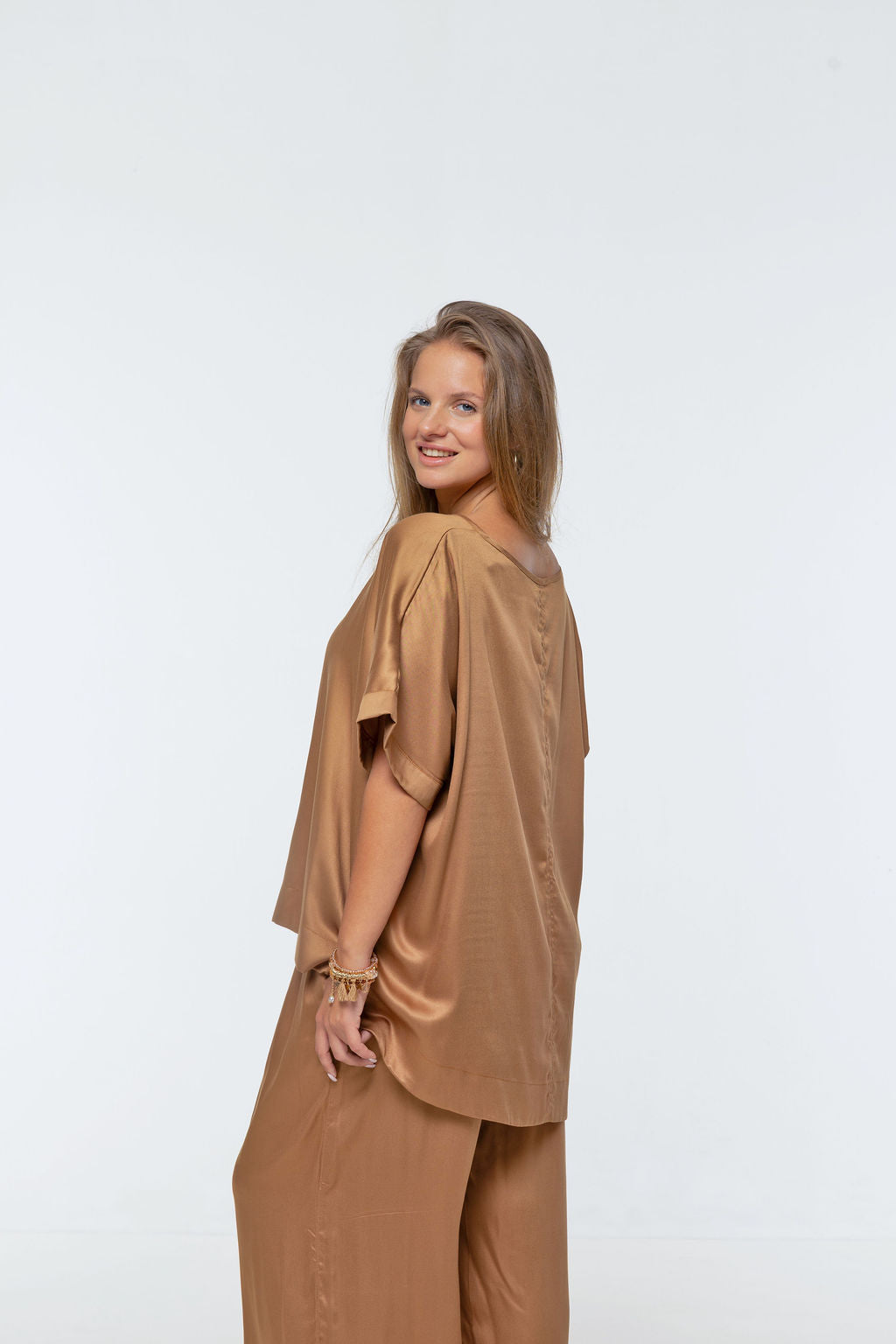 Woman wearing Salina Top in Walnut - Luxe Satin. Relaxed fit, elbow length Dolman sleeve