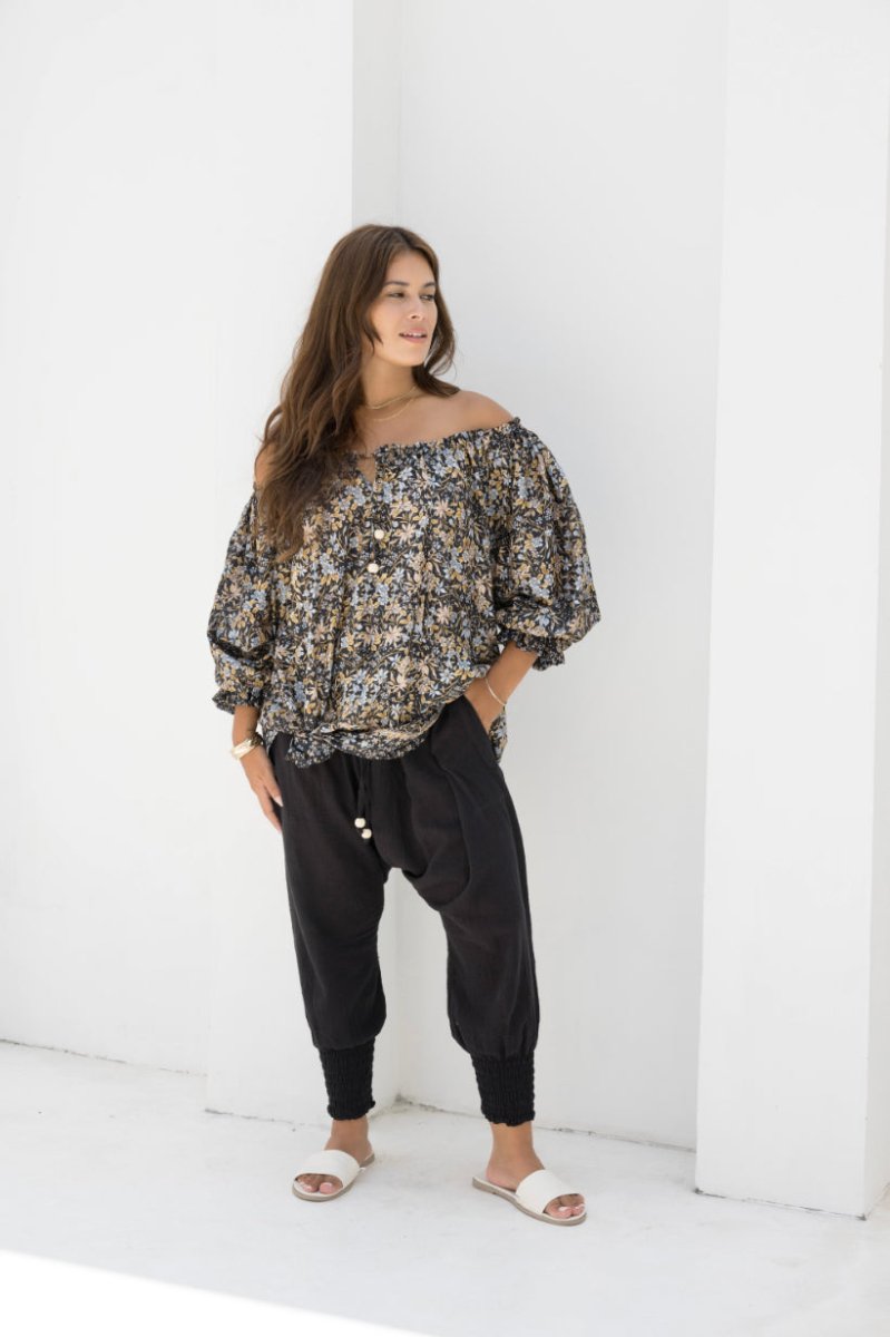 Woman wearing Moroccan Pant in Black. Harem style, relaxed fit, with shirred elastic cuff.