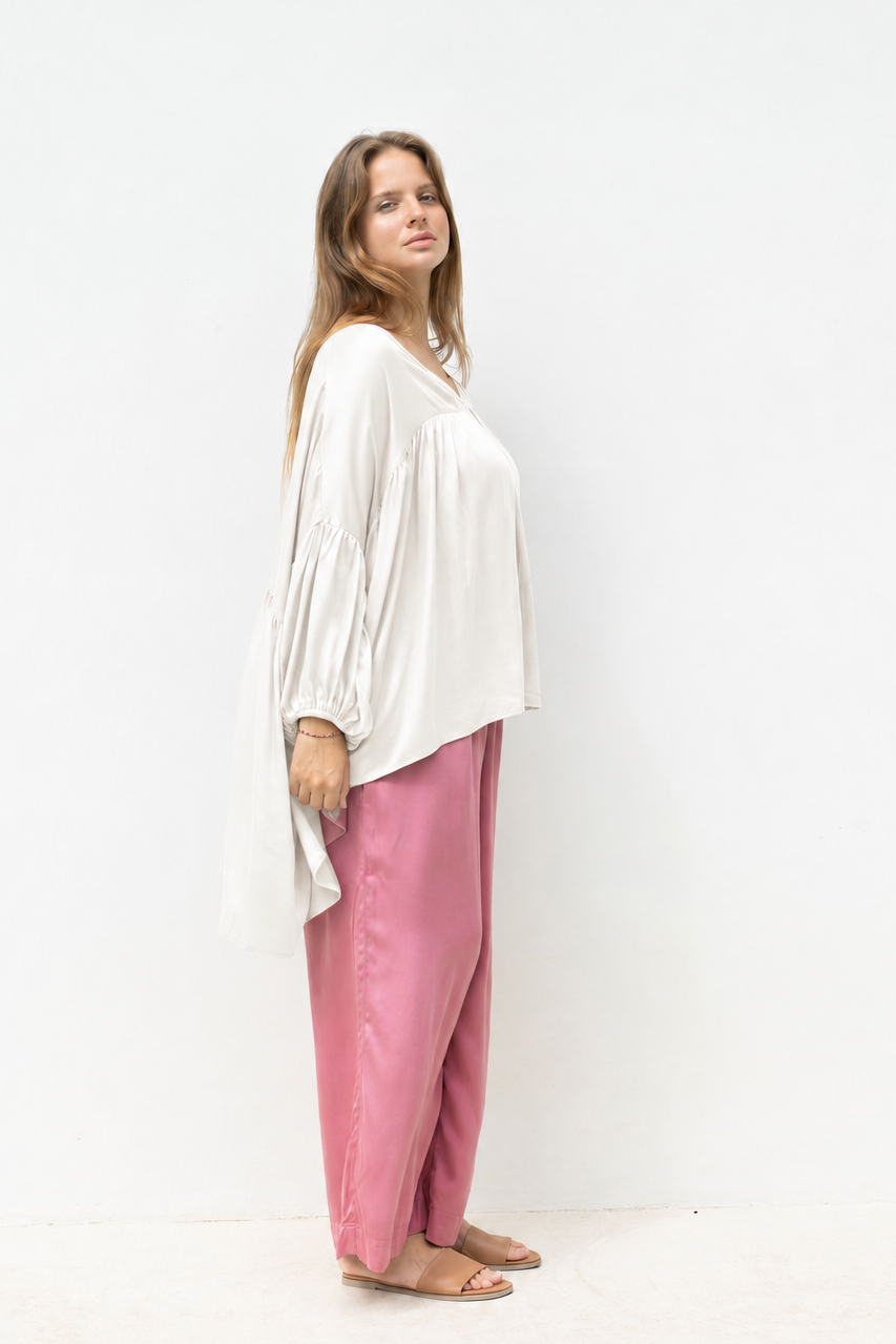 Woman wearing the Florence Top in White Sand, relaxed oversized fit, boho style, luxe satin fabric