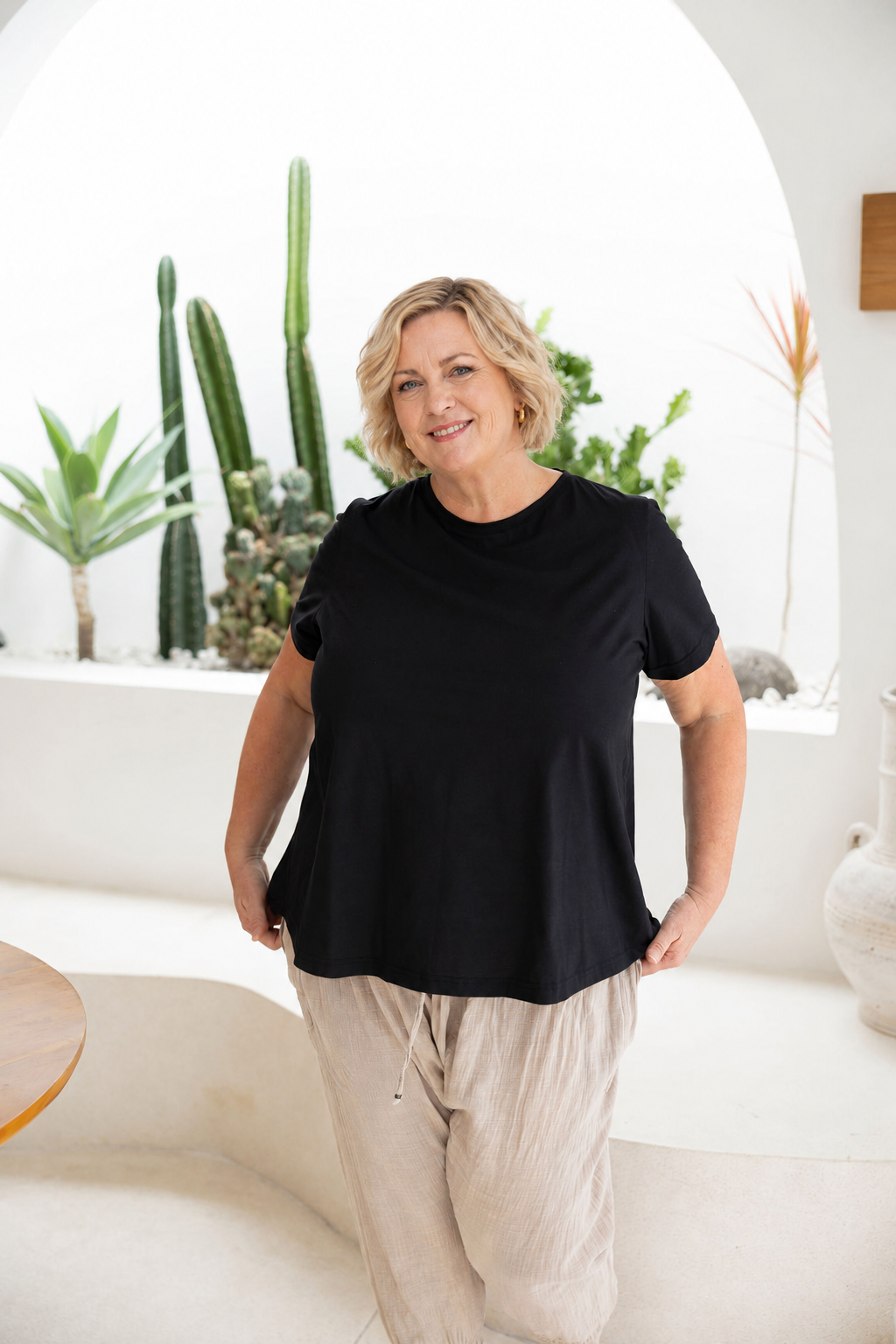 Woman wearing Monaco Top in Black. Relaxed  fit, a-line silhouette t-shirt, 100% cotton.