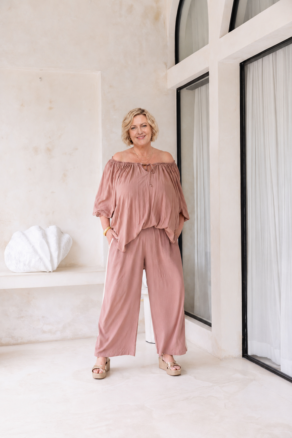 Woman wearing the Perfect Tuxedo Pant in Mocca with Stone Stripe, fluid wide-leg fit, effortlessly elevated style