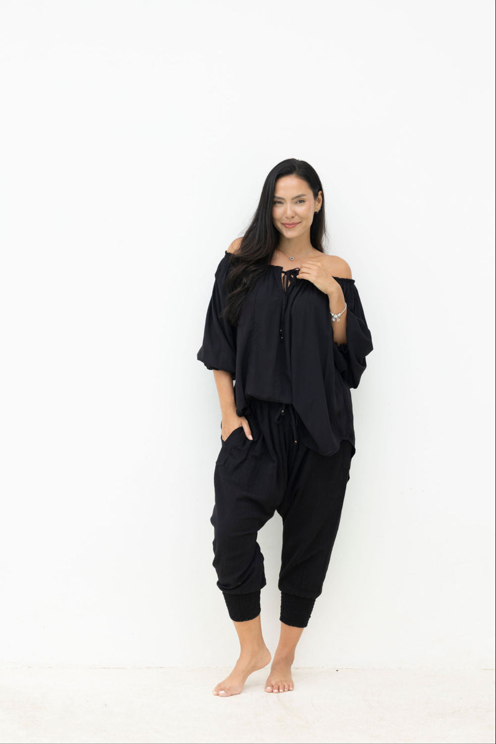 Woman wearing a black outfit with a white background
