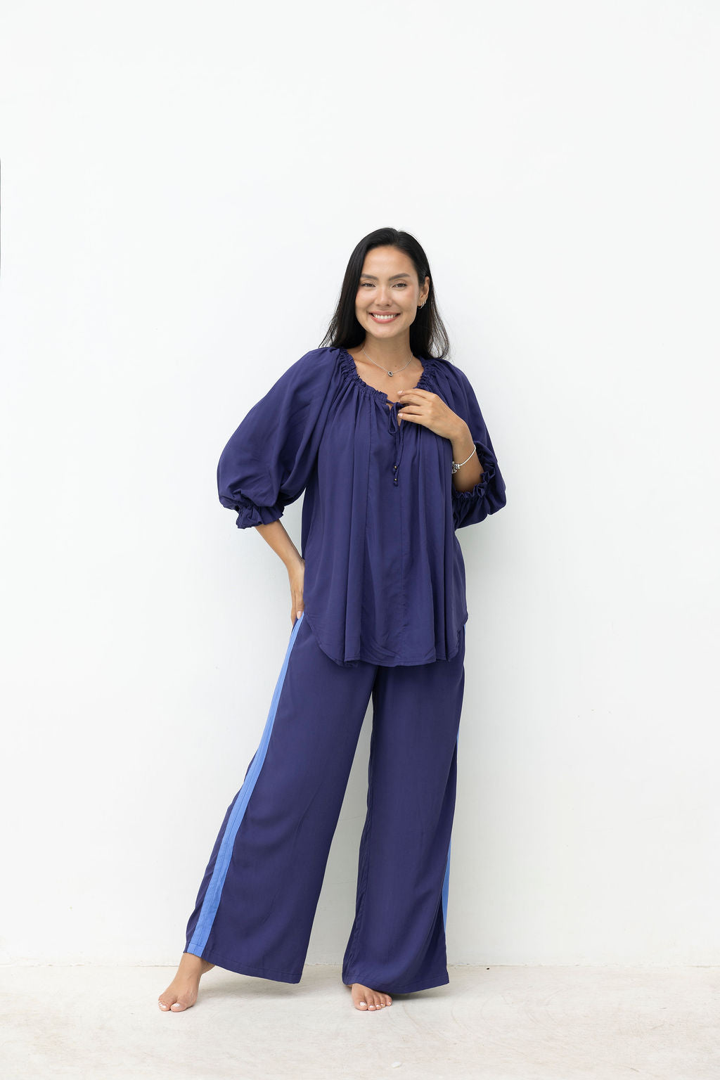 Woman wearing a blue outfit with a white background