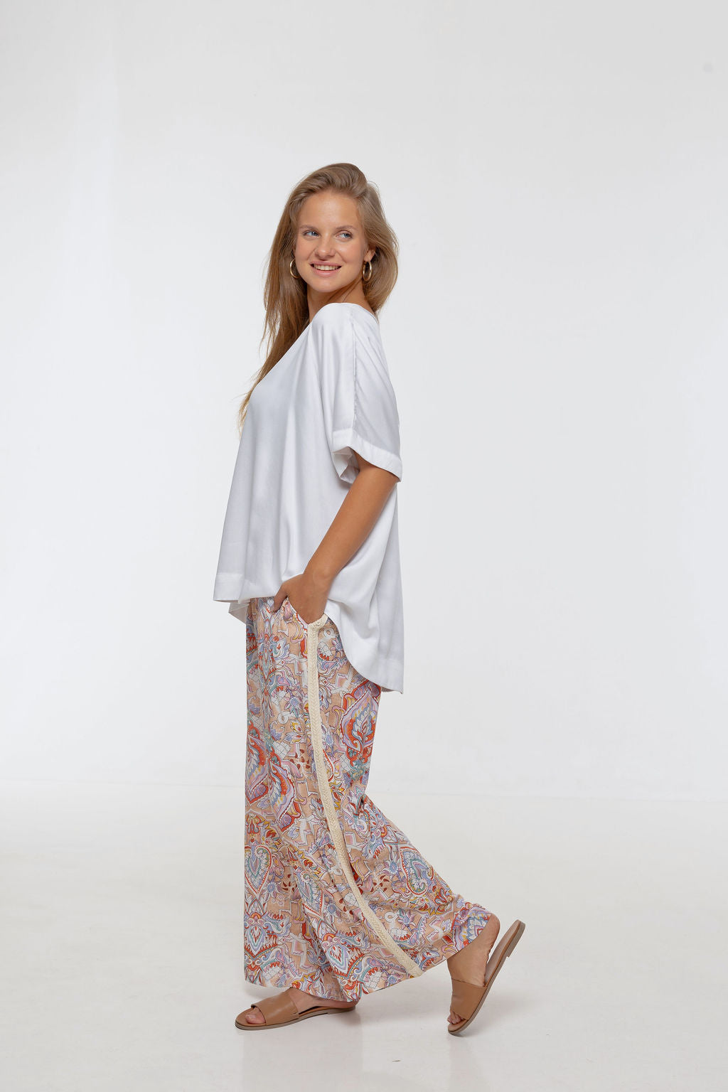 Woman wearing printed Rimini Pant. Wide leg style, relaxed fit, Braided Trim side stripe.