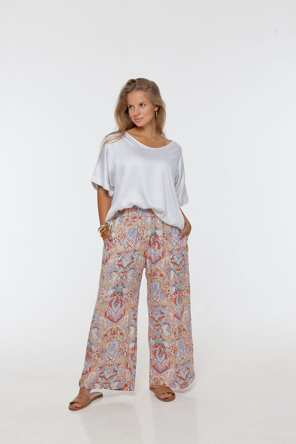 Woman wearing printed Rimini Pant. Wide leg style, relaxed fit, Braided Trim side stripe.