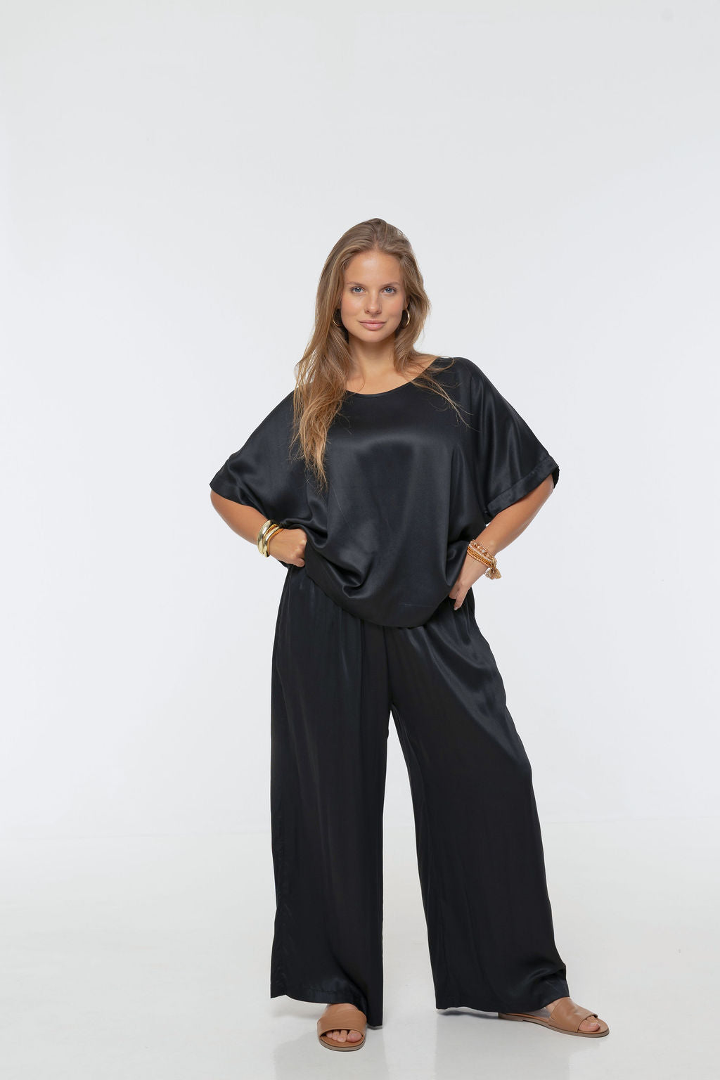 Woman wearing Rimini Pant in Black - Luxe Satin.  Wide leg style, relaxed fit.