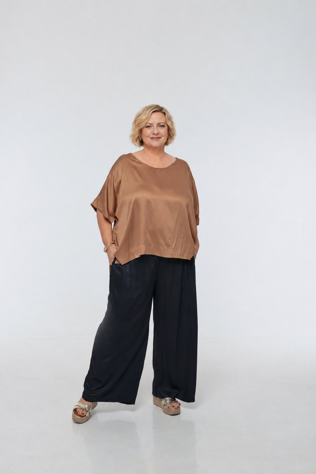 Woman wearing Rimini Pant in Black - Luxe Satin.  Wide leg style, relaxed fit.