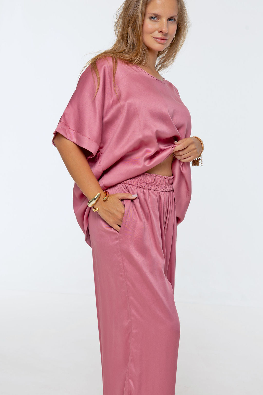 Woman wearing Rimini Pant in Dusty Pink - Luxe Satin.  Wide leg style, relaxed fit.