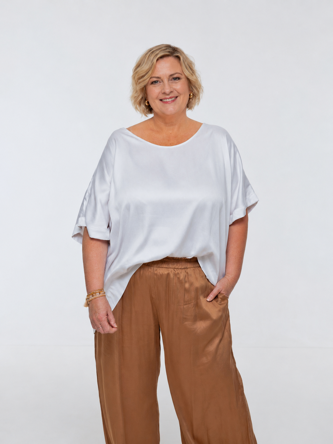Woman wearing Salina Top in White Sand - Luxe Satin.  Relaxed fit, elbow length Dolman sleeve 