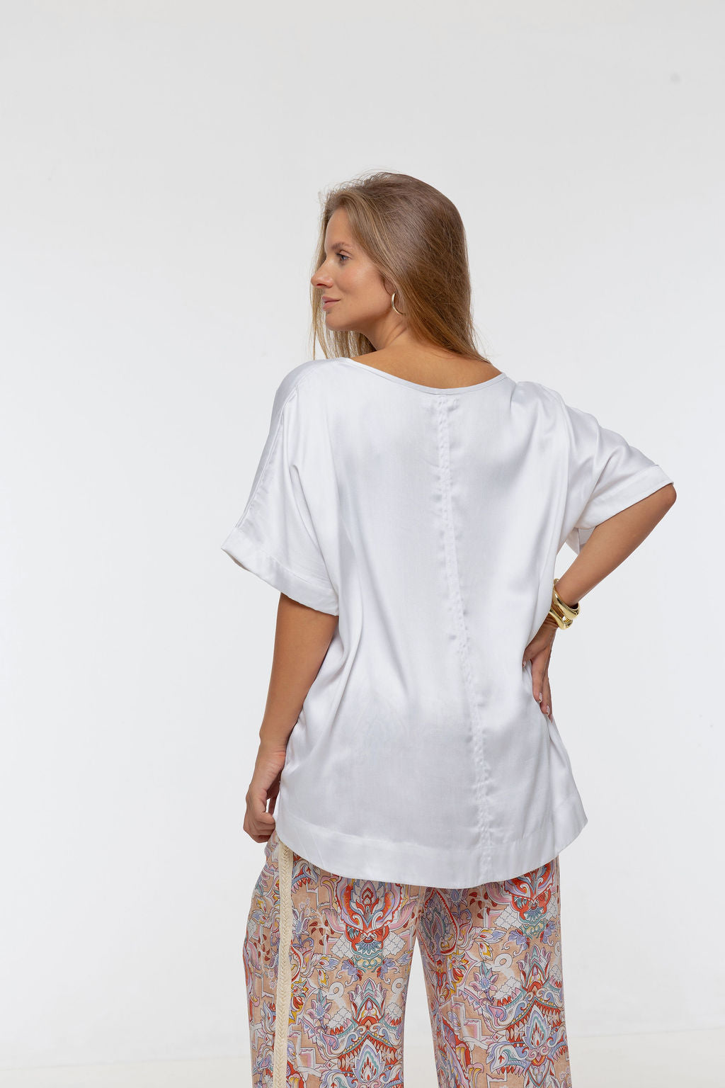Woman wearing Salina Top in White Sand - Luxe Satin.  Relaxed fit, elbow length Dolman sleeve 