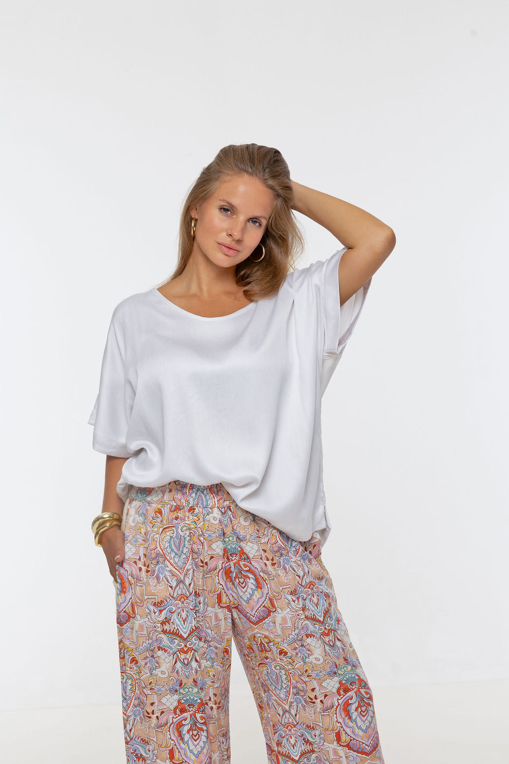 Woman wearing Salina Top in White Sand - Luxe Satin.  Relaxed fit, elbow length Dolman sleeve 
