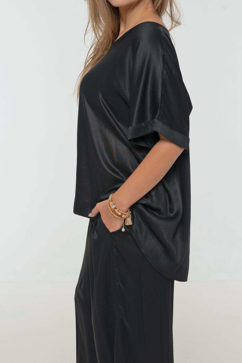 Woman wearing Salina Top in Black - Luxe Satin.  Relaxed fit, elbow length Dolman sleeve 