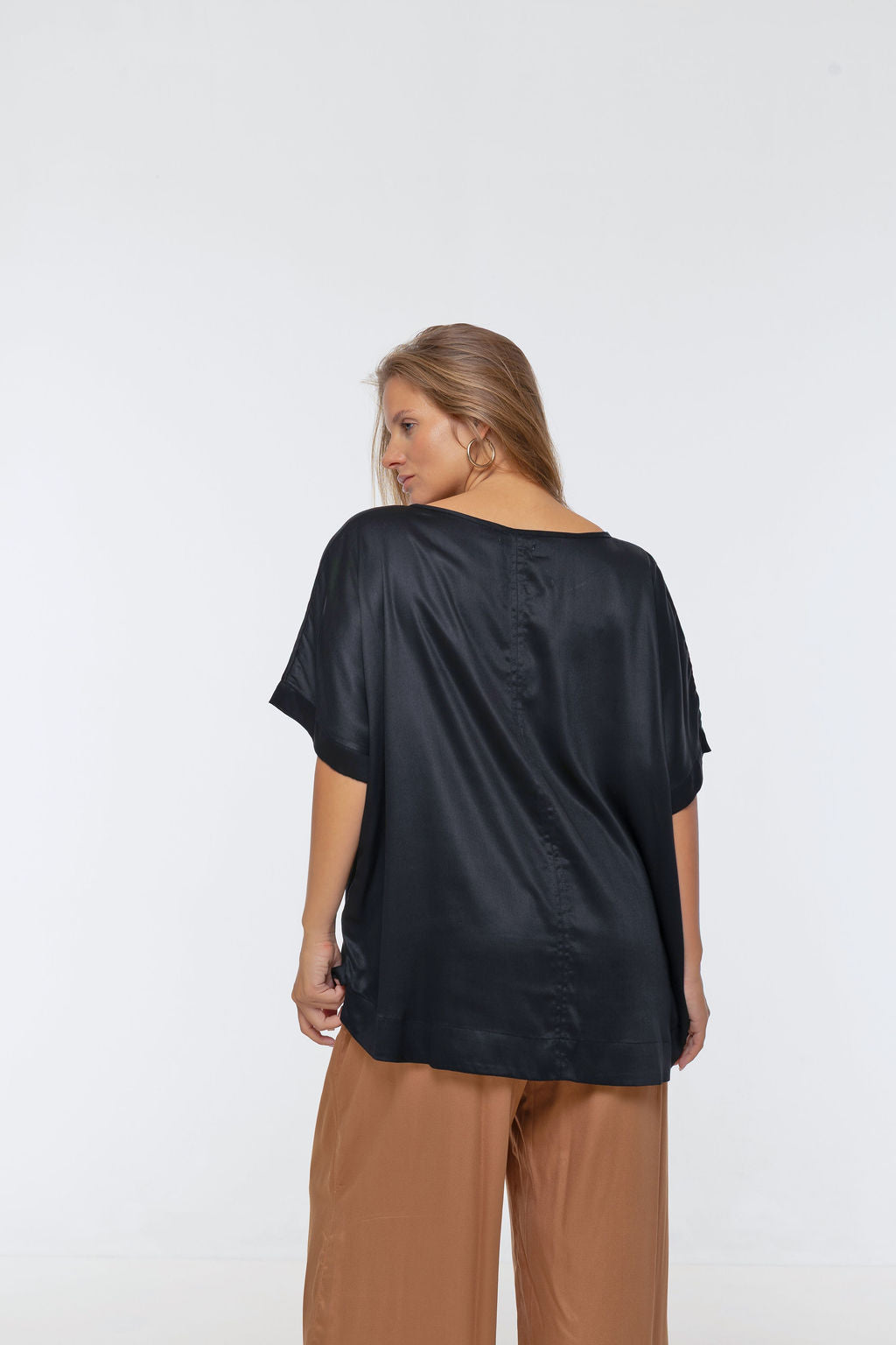 Woman wearing Salina Top in Black - Luxe Satin.  Relaxed fit, elbow length Dolman sleeve 