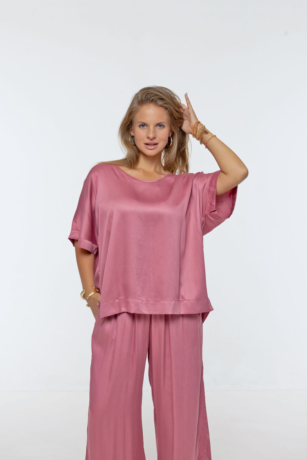 Woman wearing Salina Top in Dusted Pink - Luxe Satin.  Relaxed fit, elbow length Dolman sleeve 